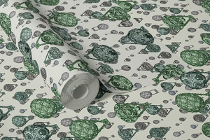 Hot Air Balloons wallpaper by Dami and Em Design in light green, partly unrolled roll showing hot-air balloons