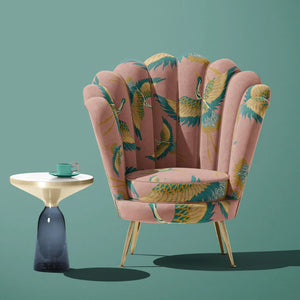 Pachamama velvet by Tatie Lou in pink, flying cranes upholstered on an armchair