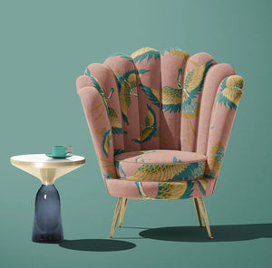 Pachamama velvet by Tatie Lou in pink, flying cranes upholstered on an armchair