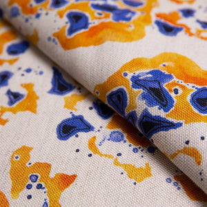 Inky linen by Bethie Tricks in blue and orange, draped, showing inky blots