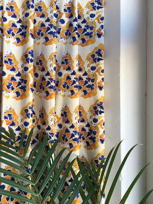 Inky linen by Bethie Tricks in blue and orange, inky blots made into curtains