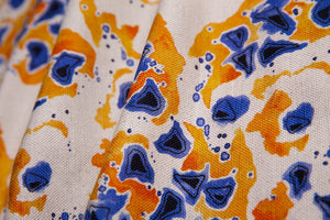 Inky linen by Bethie Tricks in blue and orange, close-up of inky blots
