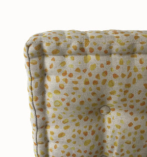 Inky linen by Bethie Tricks in yellow, inky blots as a cushion