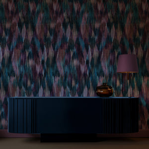 Spectre Ikat wallpaper by Victoria Sanders in red, a blurred ikat design above a sideboard