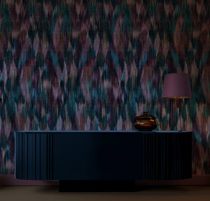Spectre Ikat wallpaper by Victoria Sanders in red, a blurred ikat design above a sideboard
