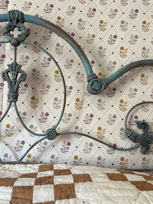 Jaipur wallpaper by Parker and Jules in cream and yellow, block-print flowers on a trellis in a bedroom
