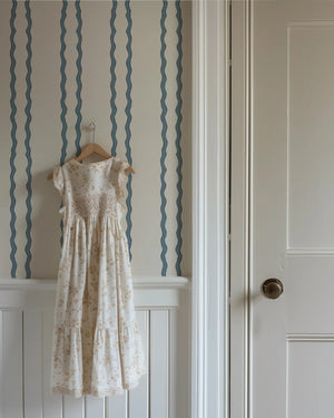 Jester Lines wallpaper by Annika Reed in blue, wavy jester lines in a hallway