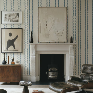 Jester Lines wallpaper by Annika Reed in blue, wavy jester lines around a fireplace