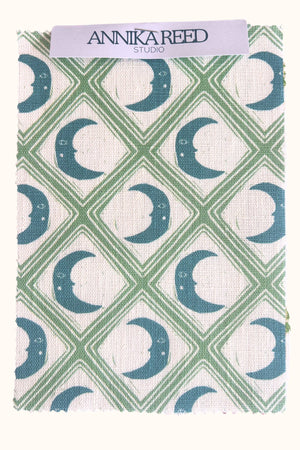 Kit Moon linen by Annika Reed in blue and green, pattern sample of crescent moons in a lattice