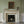 Kit Moon wallpaper by Annika Reed in blue and green, crescent moons in a lattice around a fireplace