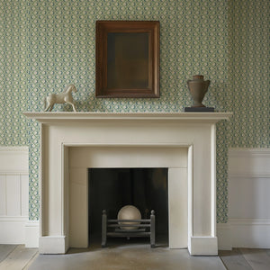 Kit Moon wallpaper by Annika Reed in blue and green, crescent moons in a lattice around a fireplace
