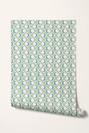 Kit Moon wallpaper by Annika Reed in blue and green, roll showing crescent moons in a lattice