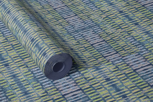 Labyrinth grasscloth by Dami and Em Design in blue and yellow, roll showing a woven ikat design