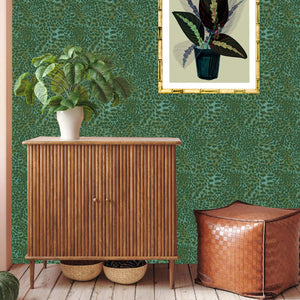 Leopard wallpaper by Tatie Lou in green, a leopard-spot print above a sideboard