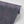Leopard wallpaper by Tatie Lou in burgundy, partly unrolled roll showing a leopard-spot print