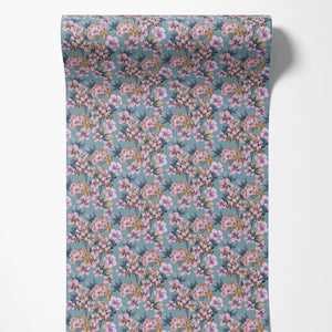 Les Fleurs wallpaper by Tatie Lou in blue and pink, partly unrolled roll showing dense painterly flowers