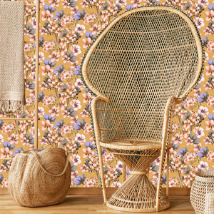 Les Fleurs wallpaper by Tatie Lou in yellow, dense painterly flowers behind a sofa in a living room