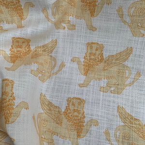 Winged Lion linen by Annika Reed in mustard, draped, showing winged lions