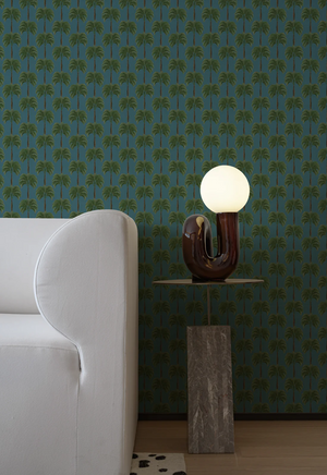 Little Palma vinyl wallpaper by Deus ex Gardenia in teal, rows of palm trees in a living room