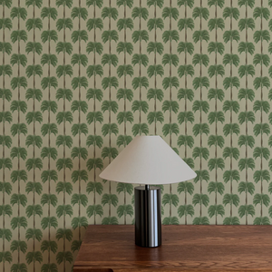 Little Palma wallpaper by Deus ex Gardenia in beige and green, rows of palm trees above a sideboard