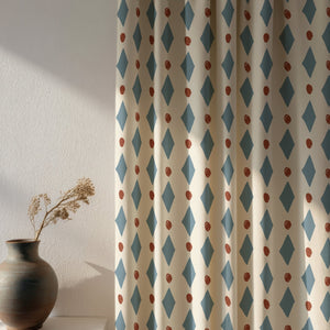 Ludo linen by Annika Reed in blue and red, diamonds and dots made into curtains