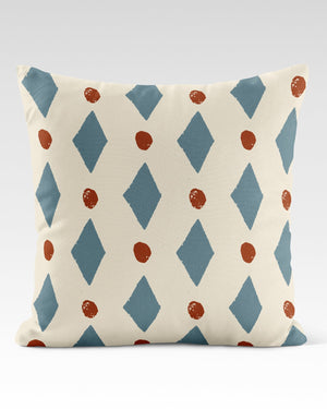 Ludo linen by Annika Reed in blue and red, diamonds and dots made into a cushion