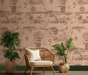 Lyons Den wallpaper by Victoria Sanders in plum, a hot-air balloon and safari toile behind a sofa in a living room