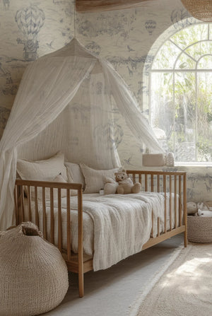 Lyons Den wallpaper by Victoria Sanders in grey, a hot-air balloon and safari toile behind a daybed in a child's room