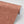 Margaux wallpaper by Tatie Lou in coral, roll showing marbled swirls