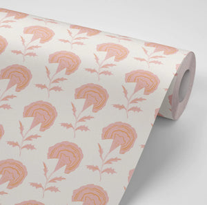 Marigold wallpaper by Annika Reed in pink, partly unrolled roll showing marigold flowers