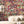 Mayhem Mansion wallpaper by Brand McKenzie in purple, animals partying in a mansion on a living room wall