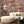 Mayhem Mansion wallpaper by Brand McKenzie in pink, animals partying in a mansion in a living room