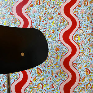 Melodie wallpaper by Claire de Quénetain in grey and red, wavy ribbon stripes in a styled room setting