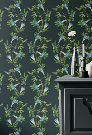 Midsummer wallpaper by Deus ex Gardenia in charcoal and green, trailing bellflowers around a fireplace