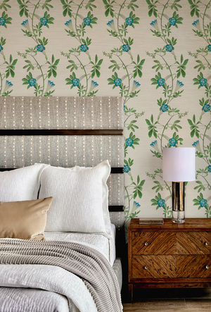 Midsummer wallpaper by Deus ex Gardenia in cream and blue, trailing bellflowers behind a bed