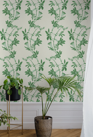 Midsummer wallpaper by Deus ex Gardenia in cream and green, trailing bellflowers behind a sofa in a living room