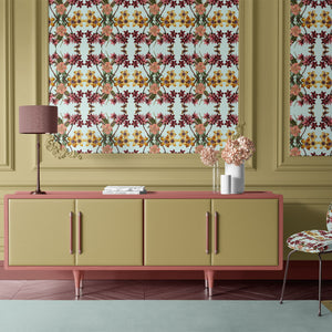 Hampi wallpaper by Tatie Lou in mint green, tropical flowers in a mirrored print above a sideboard