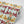 Hampi wallpaper by Tatie Lou in mint green, pattern sample of tropical flowers in a mirrored print