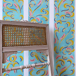 Mirage wallpaper by Claire de Quénetain in blue and pink, a hand-painted floral design in a styled room setting