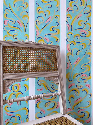 Mirage wallpaper by Claire de Quénetain in blue and pink, a hand-painted floral design in a styled room setting