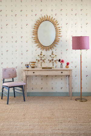 Mitford wallpaper by Parker and Jules in beige, scattered flower sprigs above a sideboard