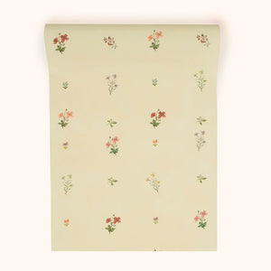 Mitford wallpaper by Parker and Jules in beige, roll showing scattered flower sprigs