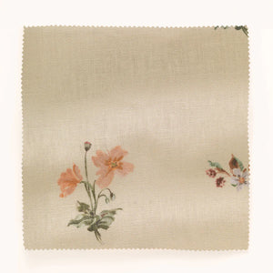 Mitford linen by Parker and Jules in beige, draped close-up of scattered embroidered flowers
