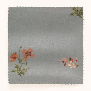 Mitford linen by Parker and Jules in grey, draped, showing scattered embroidered flowers