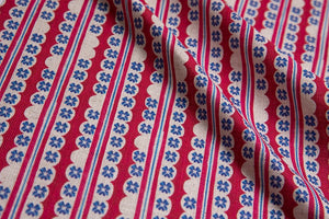 Morello linen by Bethie Tricks in red and blue, draped, showing block-print stripes