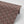 Mumbai Deco wallpaper by Tatie Lou in brown, roll showing Deco fan shapes
