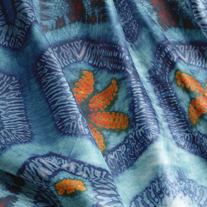 Nui Burst velvet by Tatie Lou in blue and orange, draped, showing shibori-style bursts