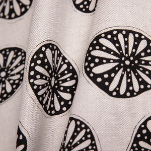 Opium linen by Bethie Tricks in black and white, full repeat of bold wheel motifs