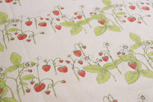 Organic Strawberry Patch linen by Seed Home Designs in red and green, in soft folds showing strawberries and flowers