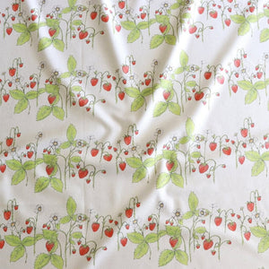 Organic Strawberry Patch linen by Seed Home Designs in red and green, draped, showing strawberries and flowers